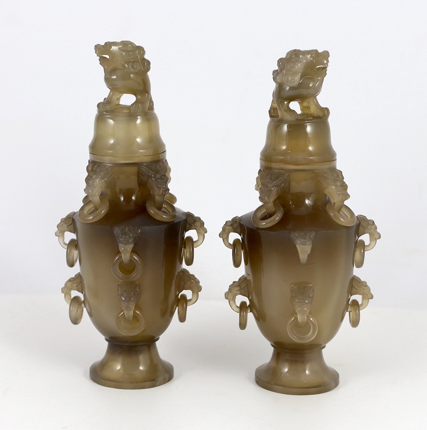 A pair of Chinese agate vases and covers, early 20th century, 19.5cm high, chip to one lion